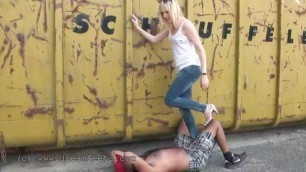 Blond German Lady Standing and Stepping on a Working Guy